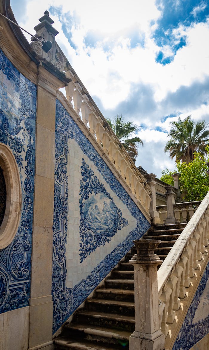 Stunning azulejos tiles adorn a staircase in Estoi, blending Portuguese artistry with sunny skies.